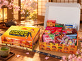 Shonen Snacks closed box beside an open box of Japanese snacks in a warm Japanese room.